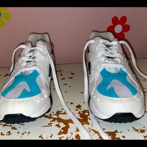 Reebok blue and white sneakers .